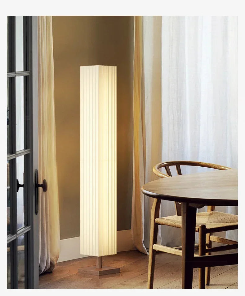 Floor lamp in a room with curtains and a table