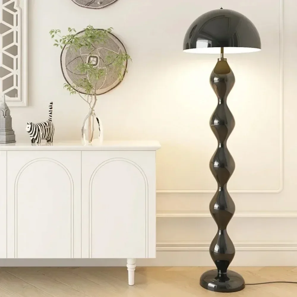 Black floor lamp in a room with a white cabinet and decorative items.