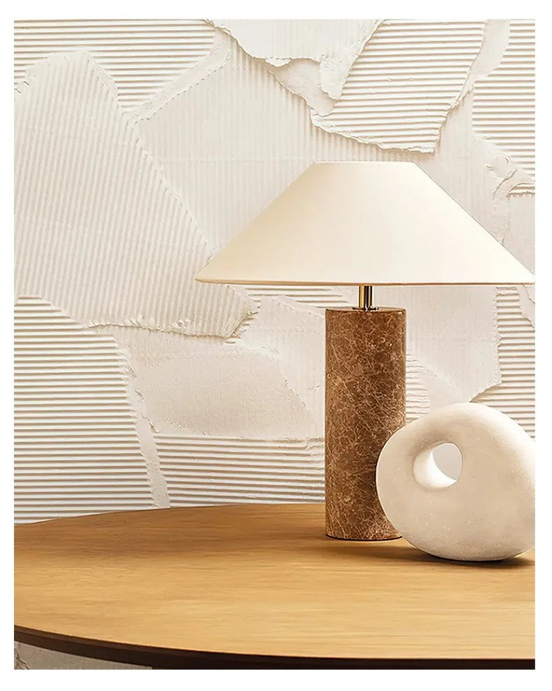 Table lamp with a textured base on a wooden surface, with text describing its dual function as a lighting tool and decoration.