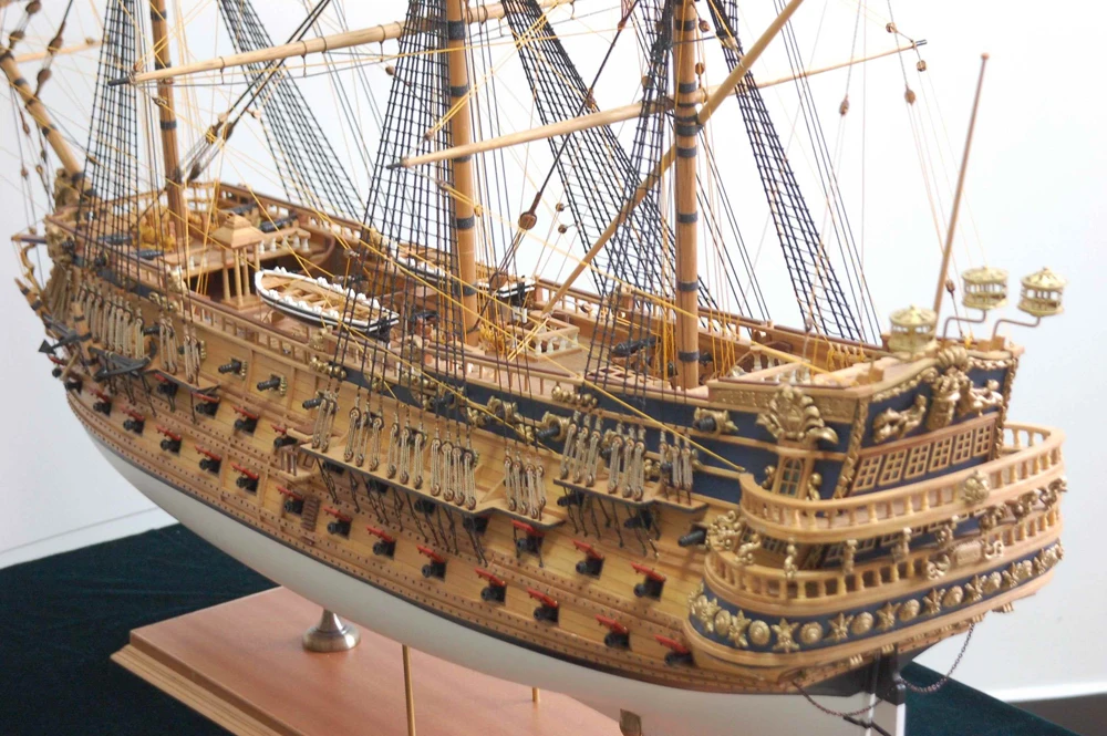 Detailed model of a large ship on a stand with a white background