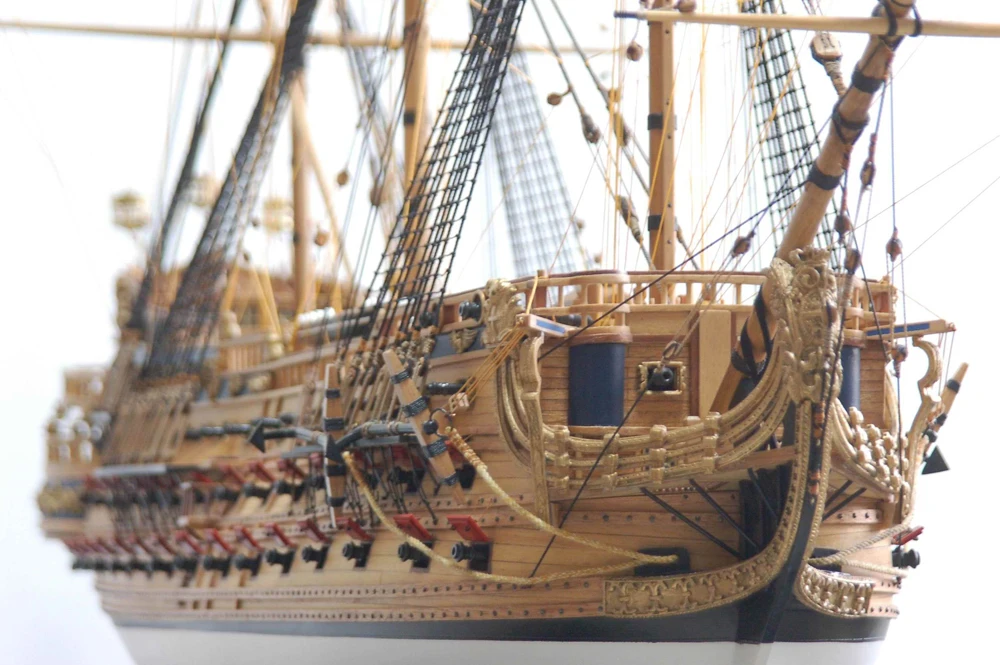 Model of a large sailing ship with intricate details on a white background